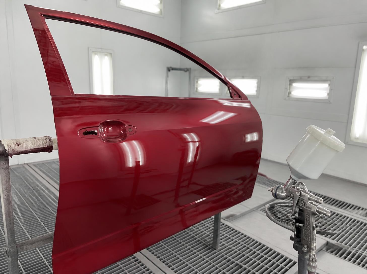 Close-up of a precisely repaired and repainted car panel with factory-quality panel gaps